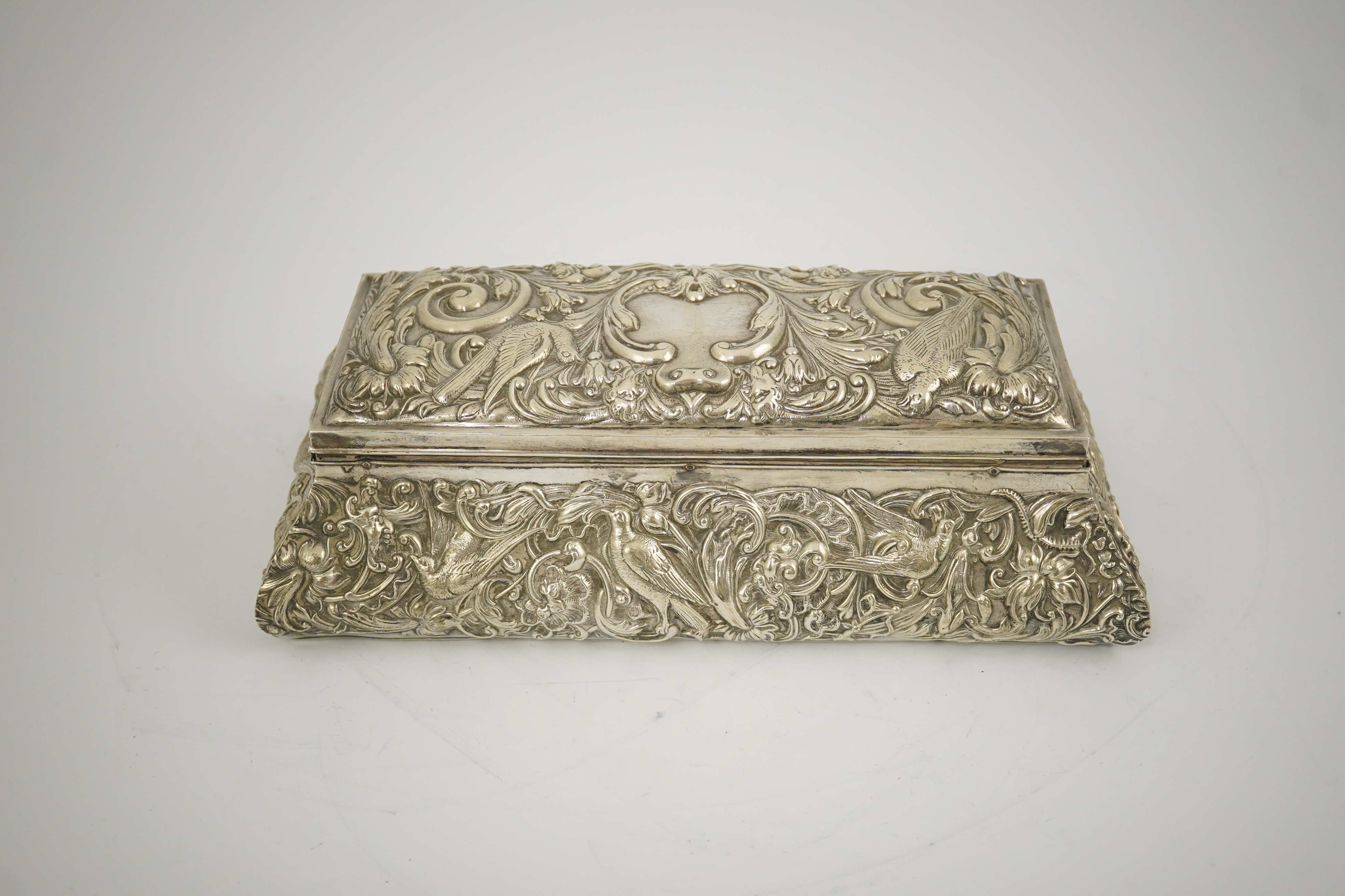 An Edwardian repousse silver mounted jewellery casket, by William Comyns